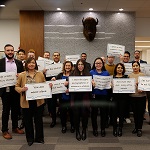 The RCMP's Integrated Homicide Investigation Team located in E-Division Headquarters each holding a Bell Let's Talk sign together supporting the cause. 