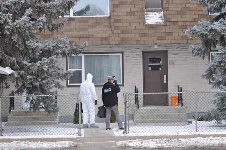 RCMP officers at the last-known residence of homicide victim Bud Paul