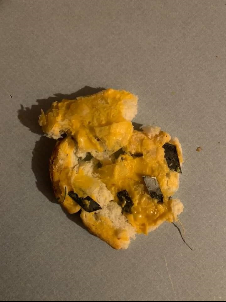 A dog owner on Bell Island found his dog chewing on this bread, stuffed with cheese spread, shards of glass and razor blades on April 27, 2021.