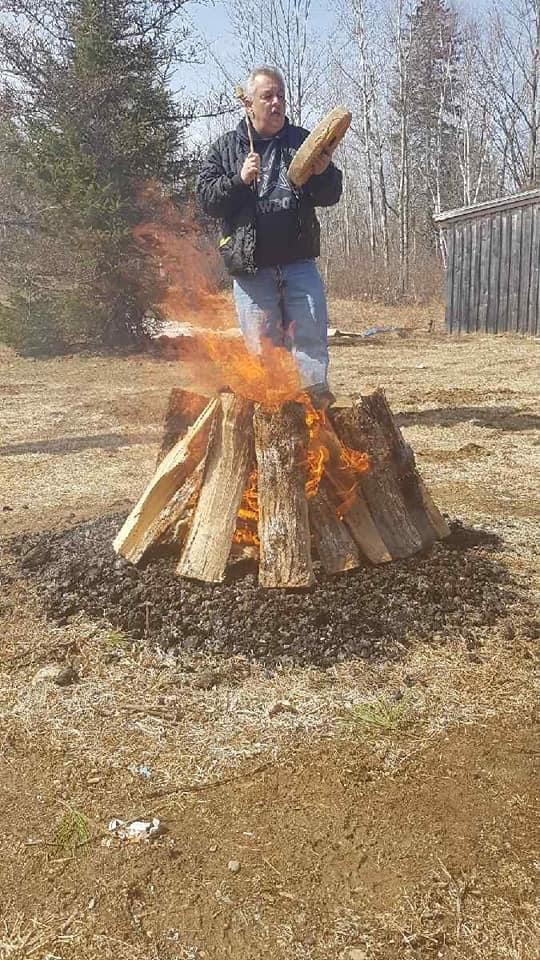 Elder Edward Perley of Neqotkuk (Tobique) First Nation drumming at a Sacred Fire