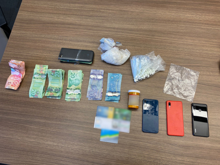 Approximately 25 grams of cocaine, divided into 25 packages, 180 grams of methamphetamine, 68 tablets of codeine, 3 cellular phones, a large sum of Canadian currency