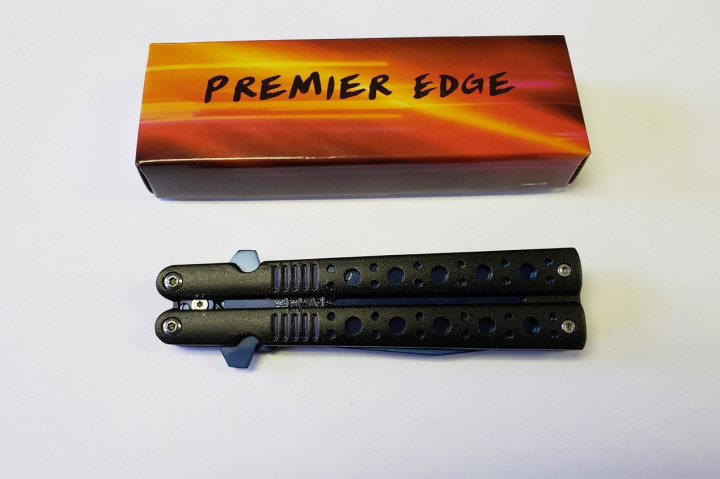 An orange and brown case, brand name Premier Edge, sits above a black switchblade knife in a closed position.