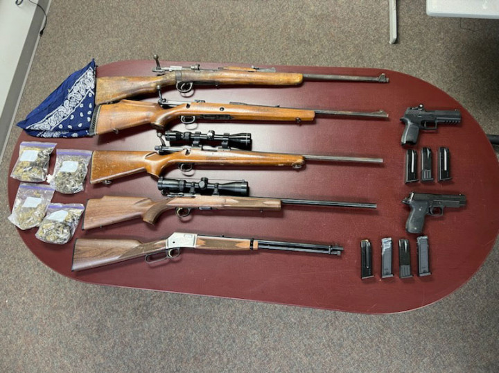 Seized five rifles, two handguns, a number of magazines with ammunition, and a quantity of psilocybin and illegal cannabis. 