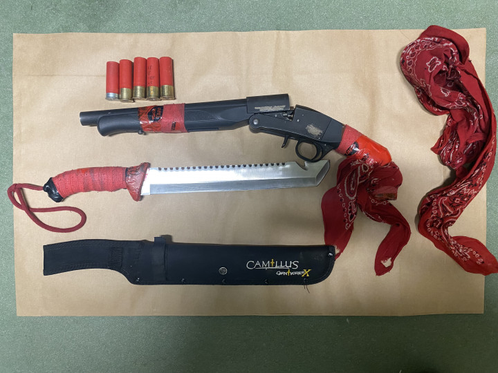 A loaded sawed-off shot gun, Machete and a red banadana