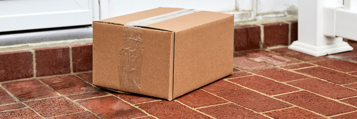 A brown parcel on a brick porch.